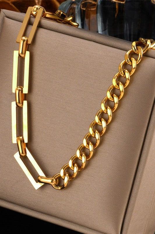 Gold chain necklace on a beige handbag