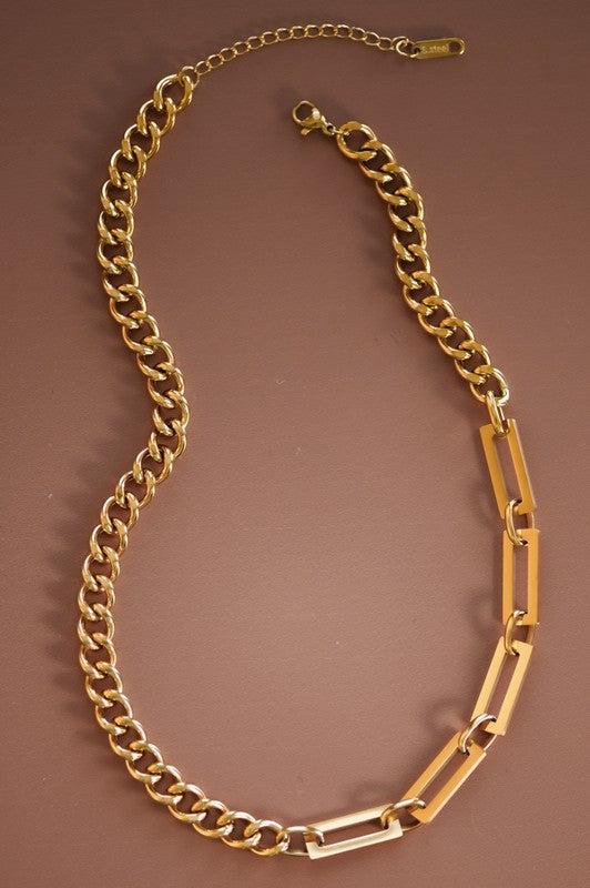 Gold chain necklace on a brown background