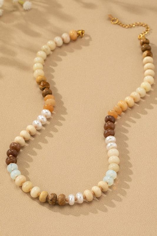 Necklace with multicolored beads on a beige background