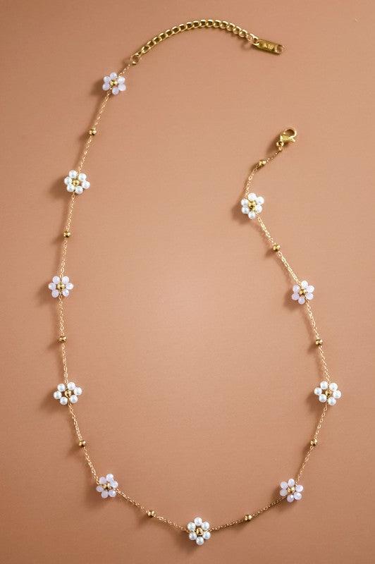 Necklace with floral pendants on a brown background