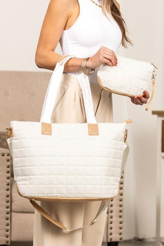 Woman holding a white nylon quilted traveler tote bag.