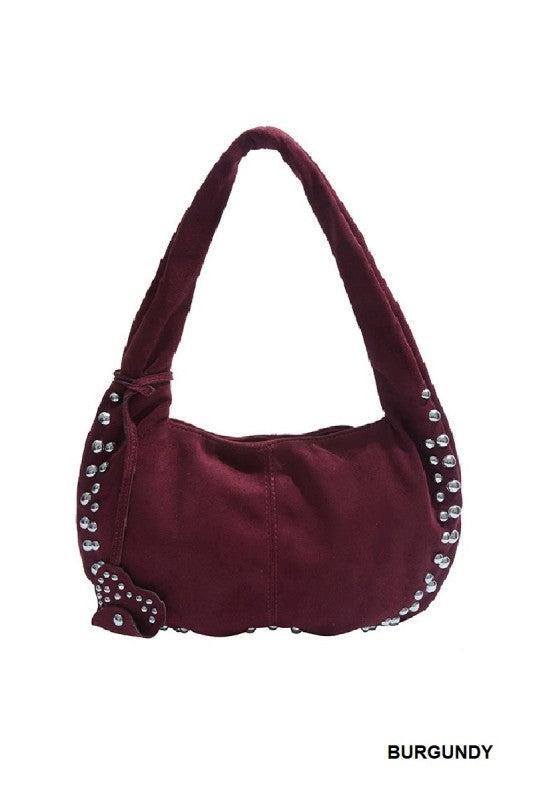 Burgundy handbag with studded details on a white background