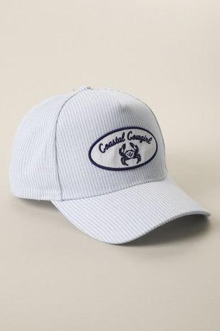 White cap with a logo on a beige background