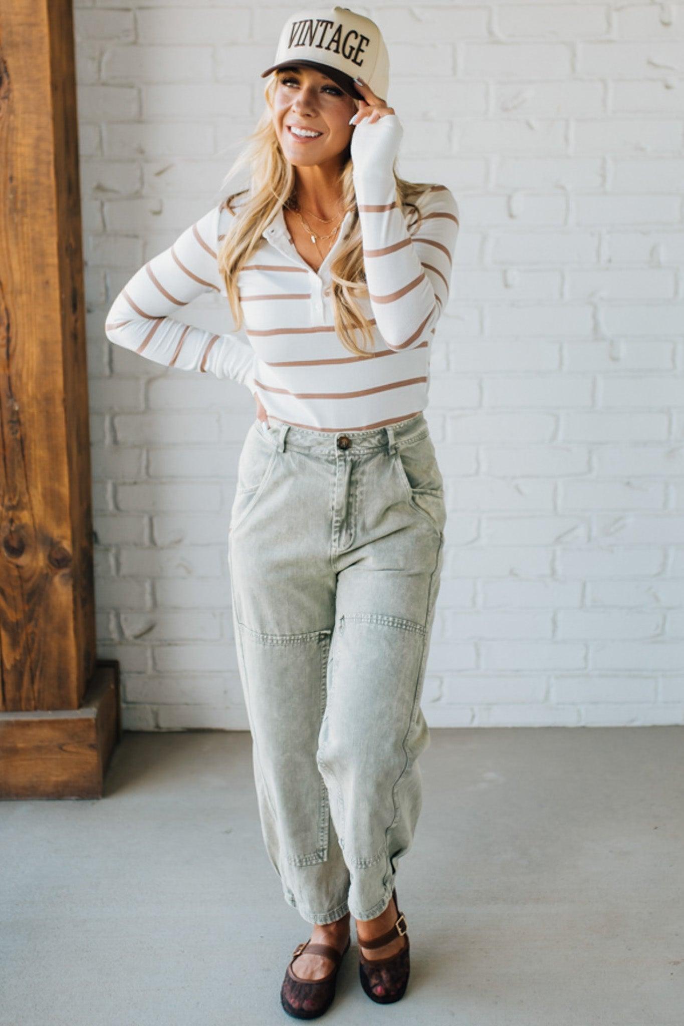 Blonde woman wearing Mineral Washed Mid Rise Barrel Shape Pants with patch detail on leg.