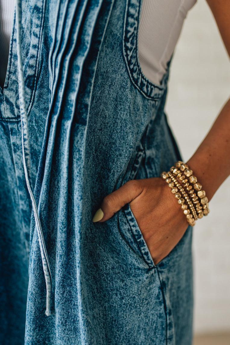 Blonde Woman Wearing a Mineral Washed Pintuck Jumpsuit With Side Pockets.