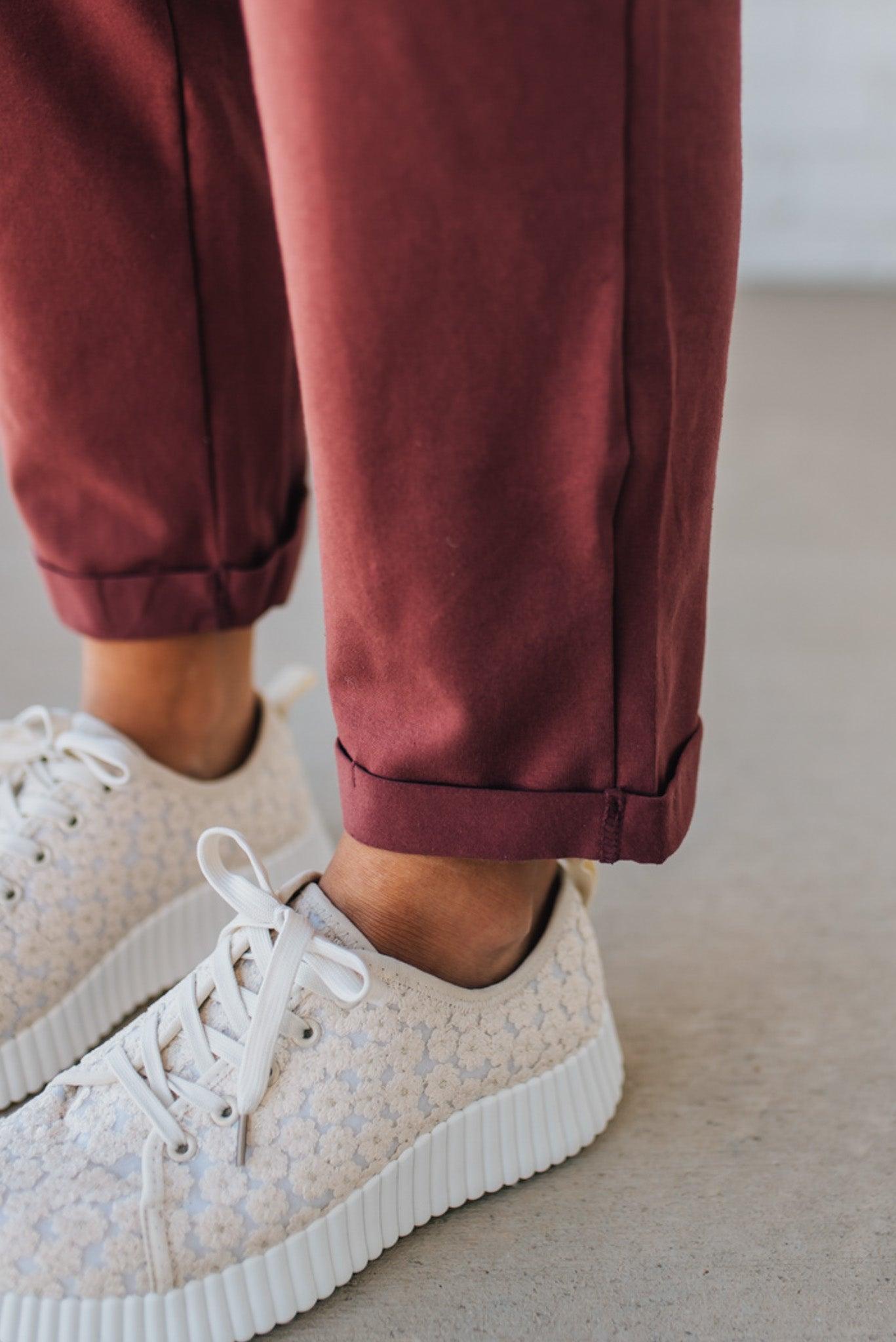 Blonde Woman wearing a white tank with a solid Cotton Relaxed Cami Jumpsuit.