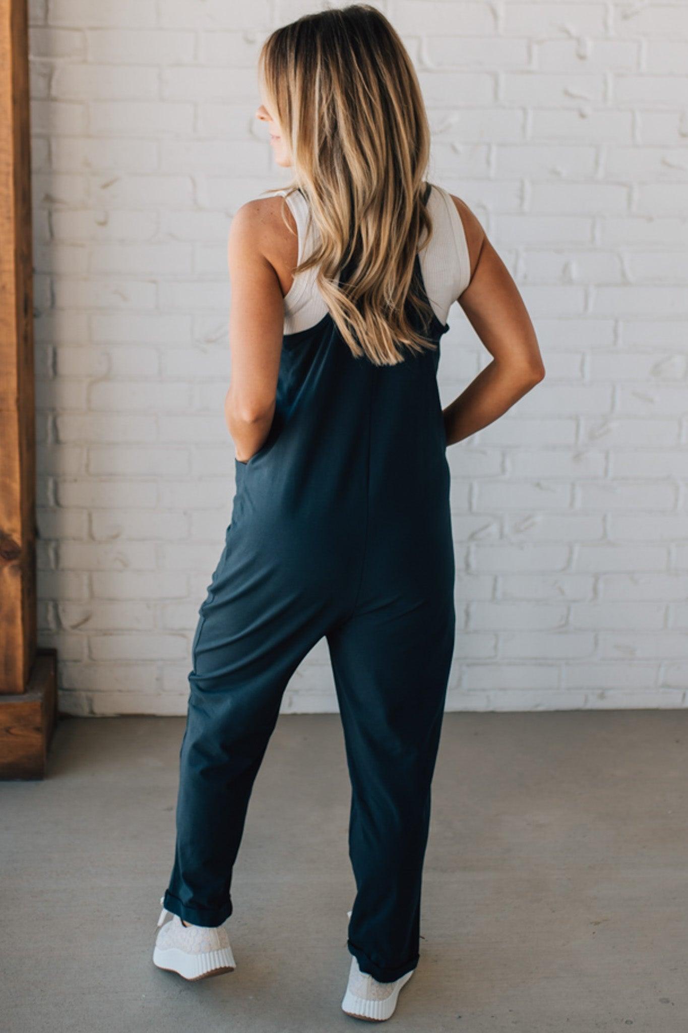 Blonde Woman wearing a white tank with a solid Cotton Relaxed Cami Jumpsuit.