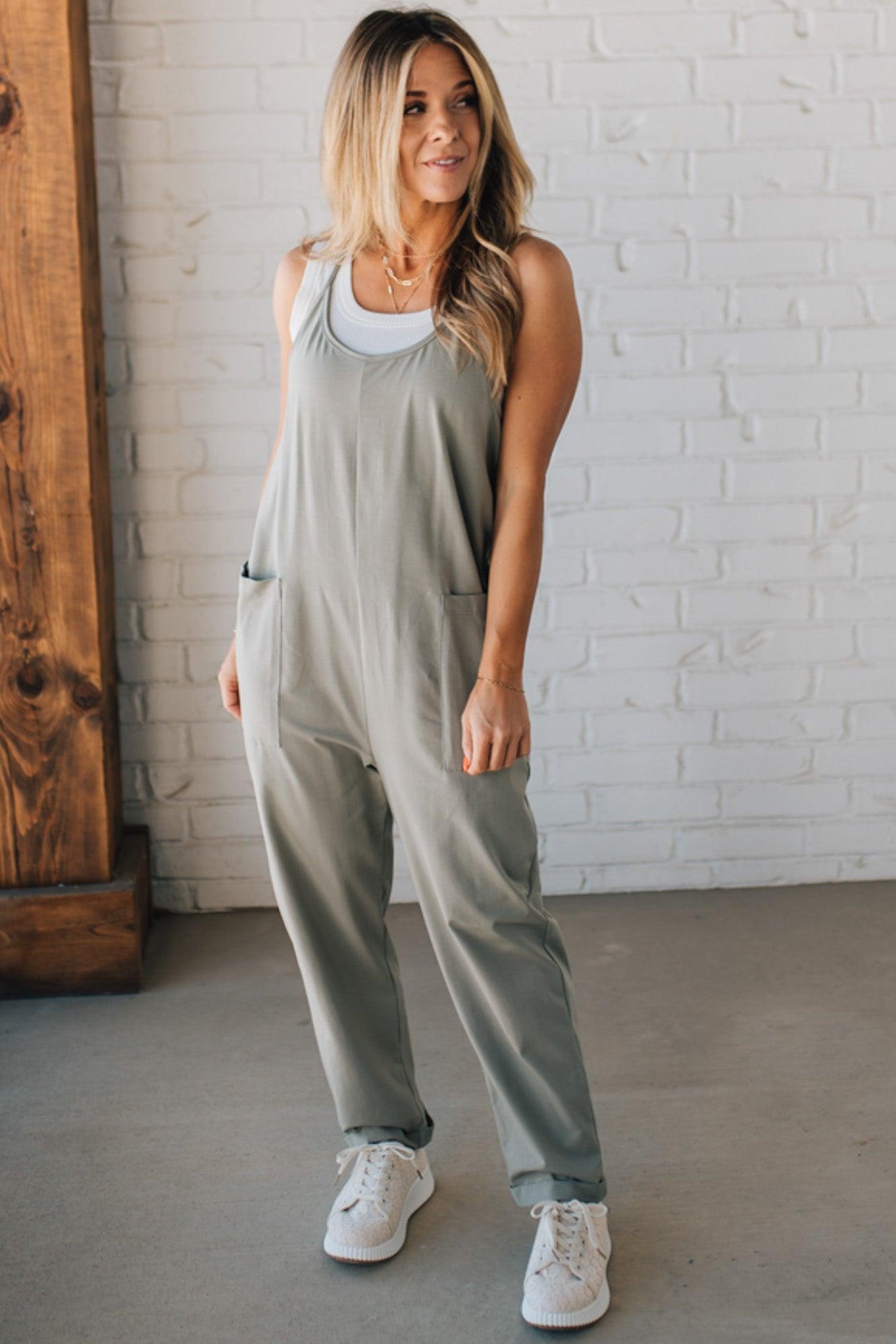 Blonde Woman wearing a white tank with a solid Cotton Relaxed Cami Jumpsuit.