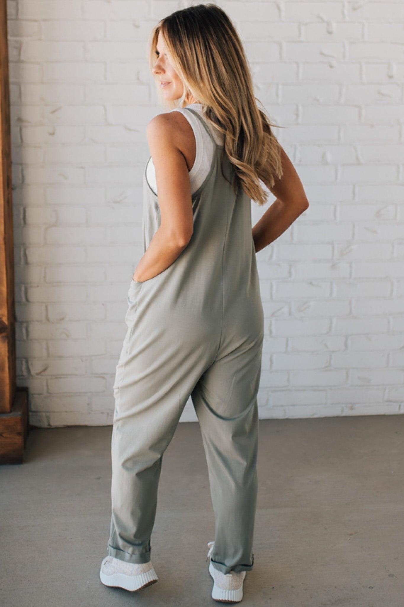 Blonde Woman wearing a white tank with a solid Cotton Relaxed Cami Jumpsuit.