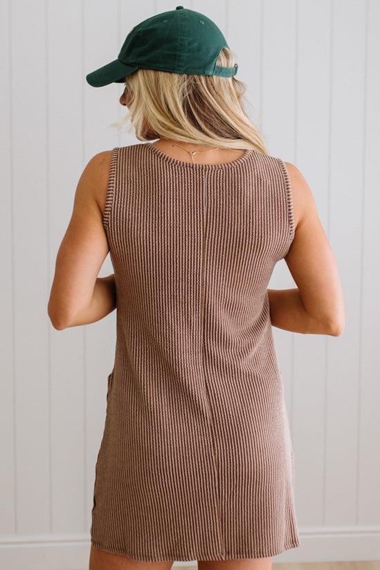 BLONDE WOMAN MODELING A RIBBED TANK DRESS WITH HENLEY STYLE WOOD BUTTONS AND TWO FRONT POCKETS
