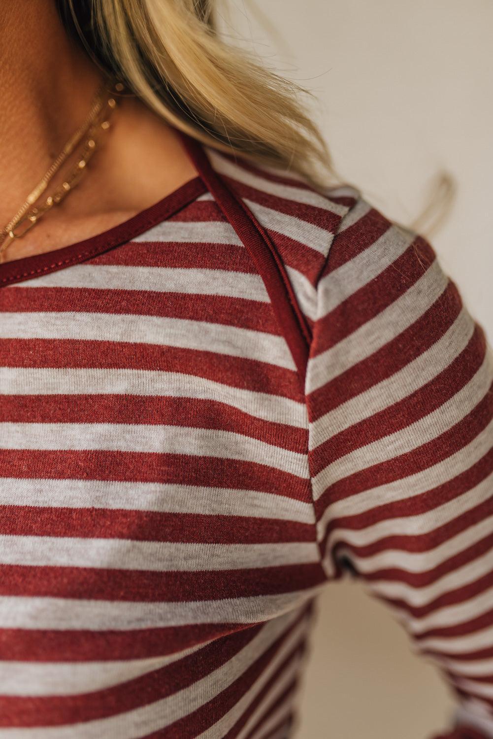 Red and white striped shirt worn by a person with a blurred background