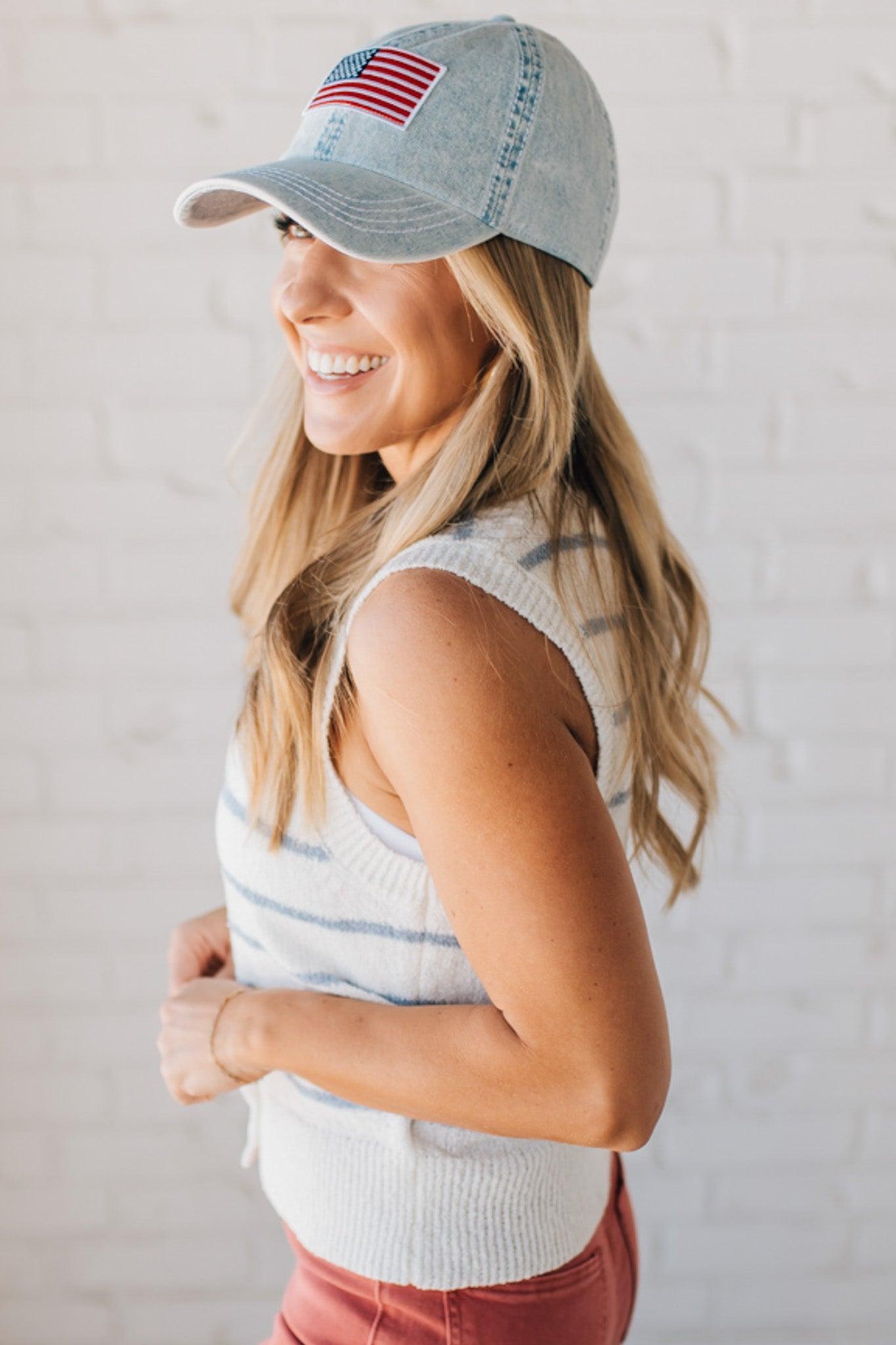 BLONDE WOMAN IN A HAT WEARING A LIGHTWEIGHT, COZY, STRIPED BUTTON UP V-NECK VEST W/ RIBBING ACCENTS THROUGHOUT BODY.