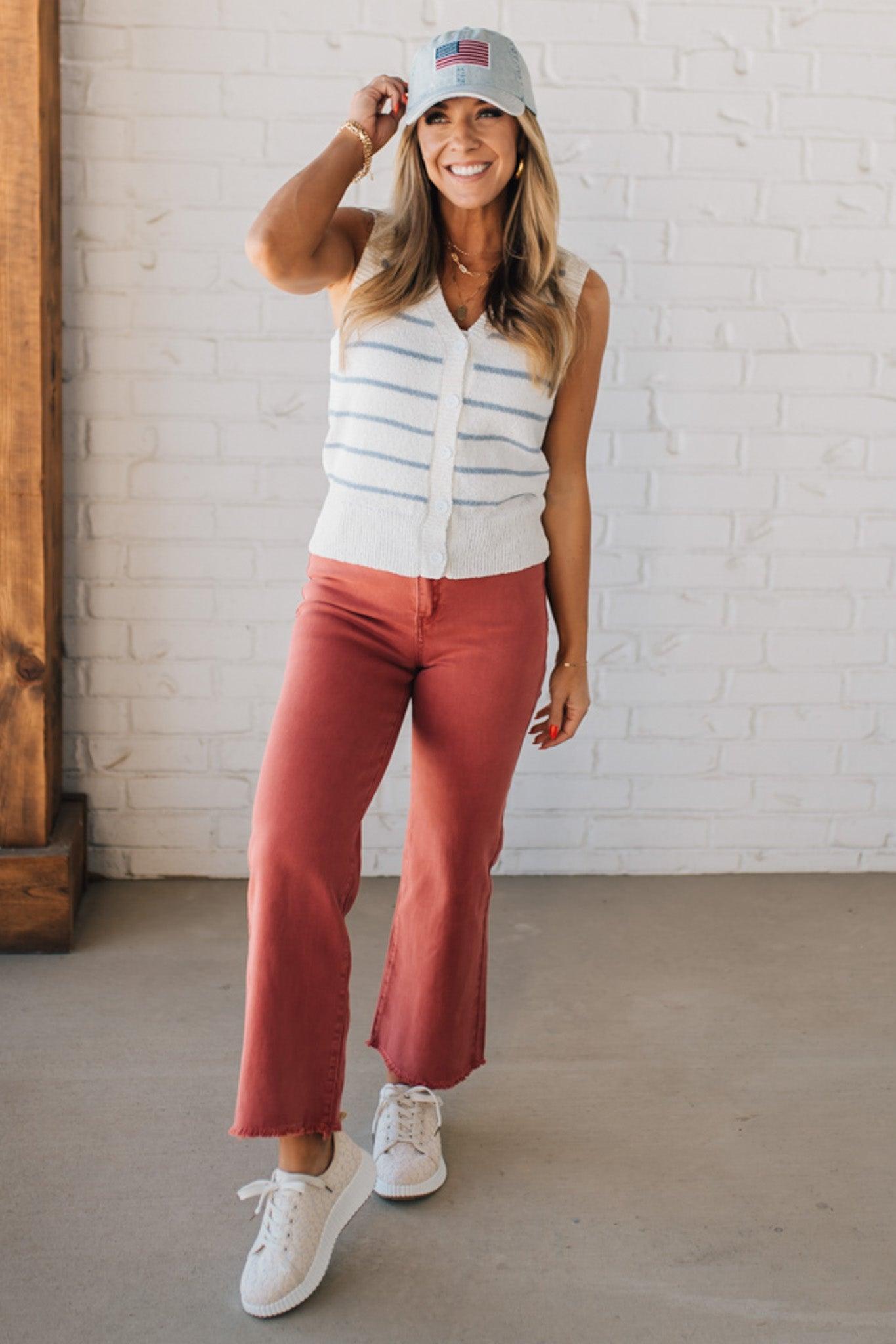 BLONDE WOMAN IN A HAT WEARING A LIGHTWEIGHT, COZY, STRIPED BUTTON UP V-NECK VEST W/ RIBBING ACCENTS THROUGHOUT BODY.