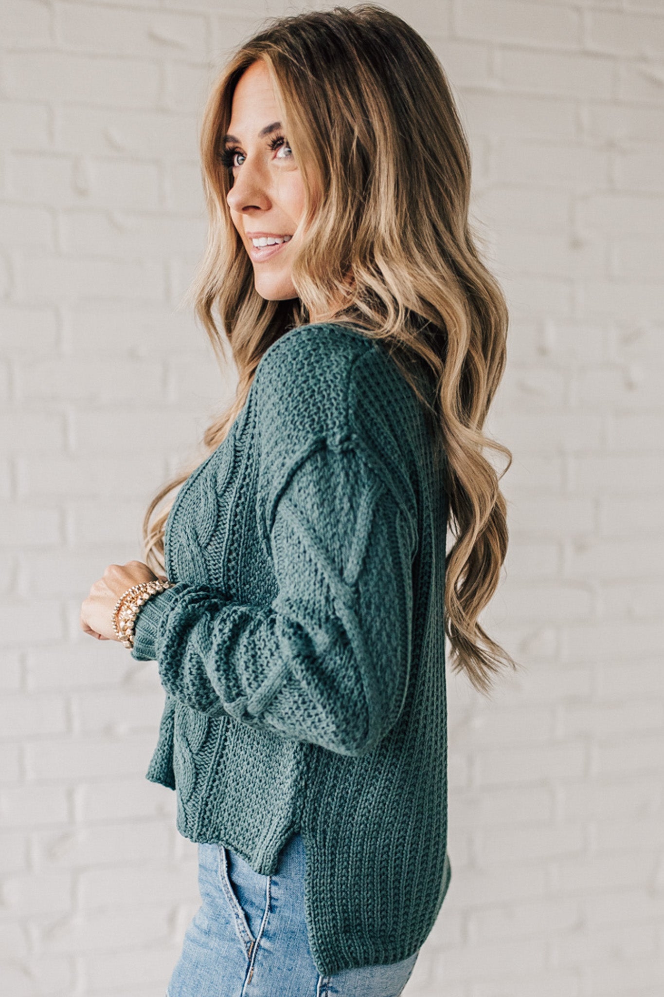 Blonde girl modeling a mocha long sleeve cable knit sweater