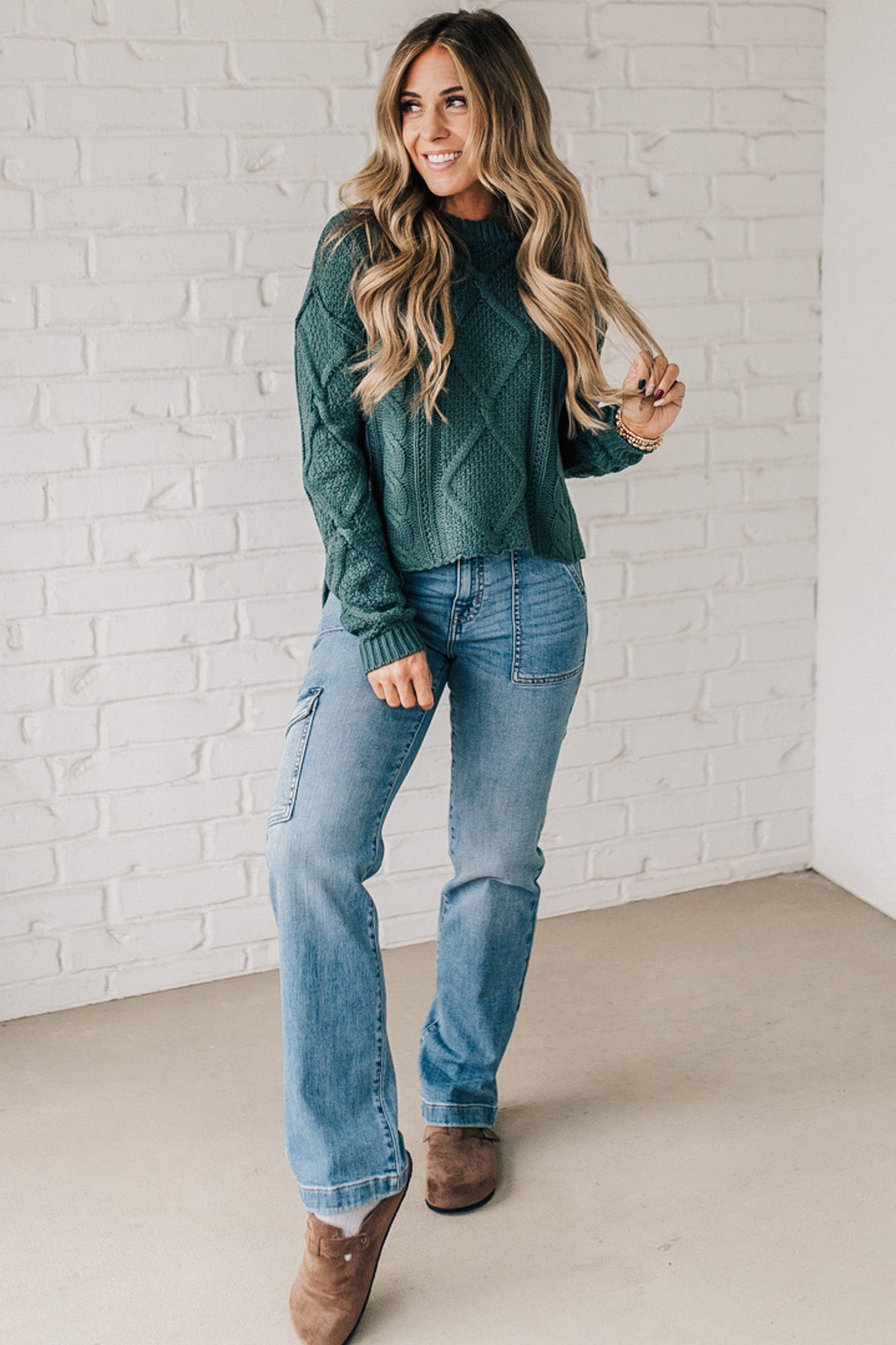 Blonde girl modeling a mocha long sleeve cable knit sweater
