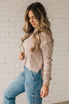Blonde girl modeling a mocha long sleeve cable knit sweater