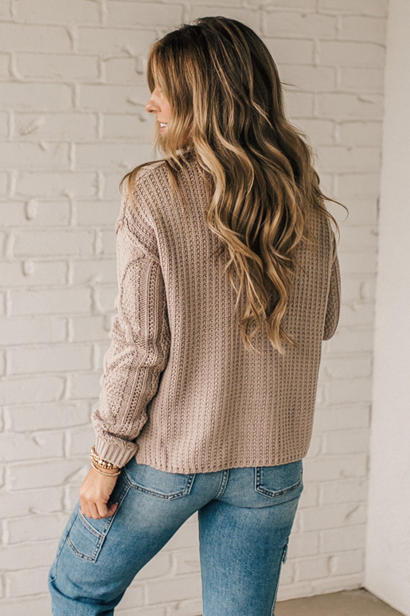 Blonde girl modeling a mocha long sleeve cable knit sweater