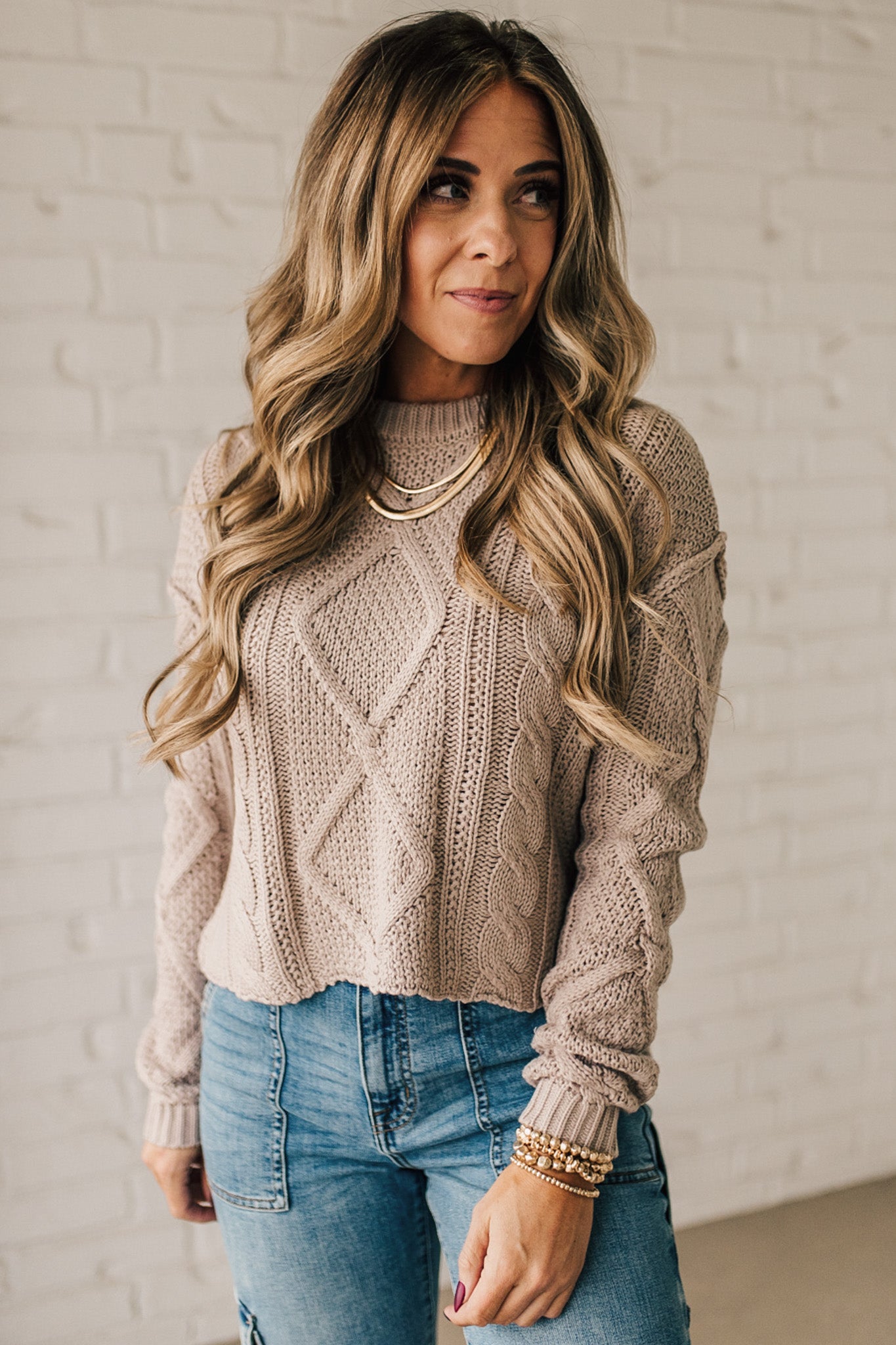 Blonde girl modeling a mocha long sleeve cable knit sweater