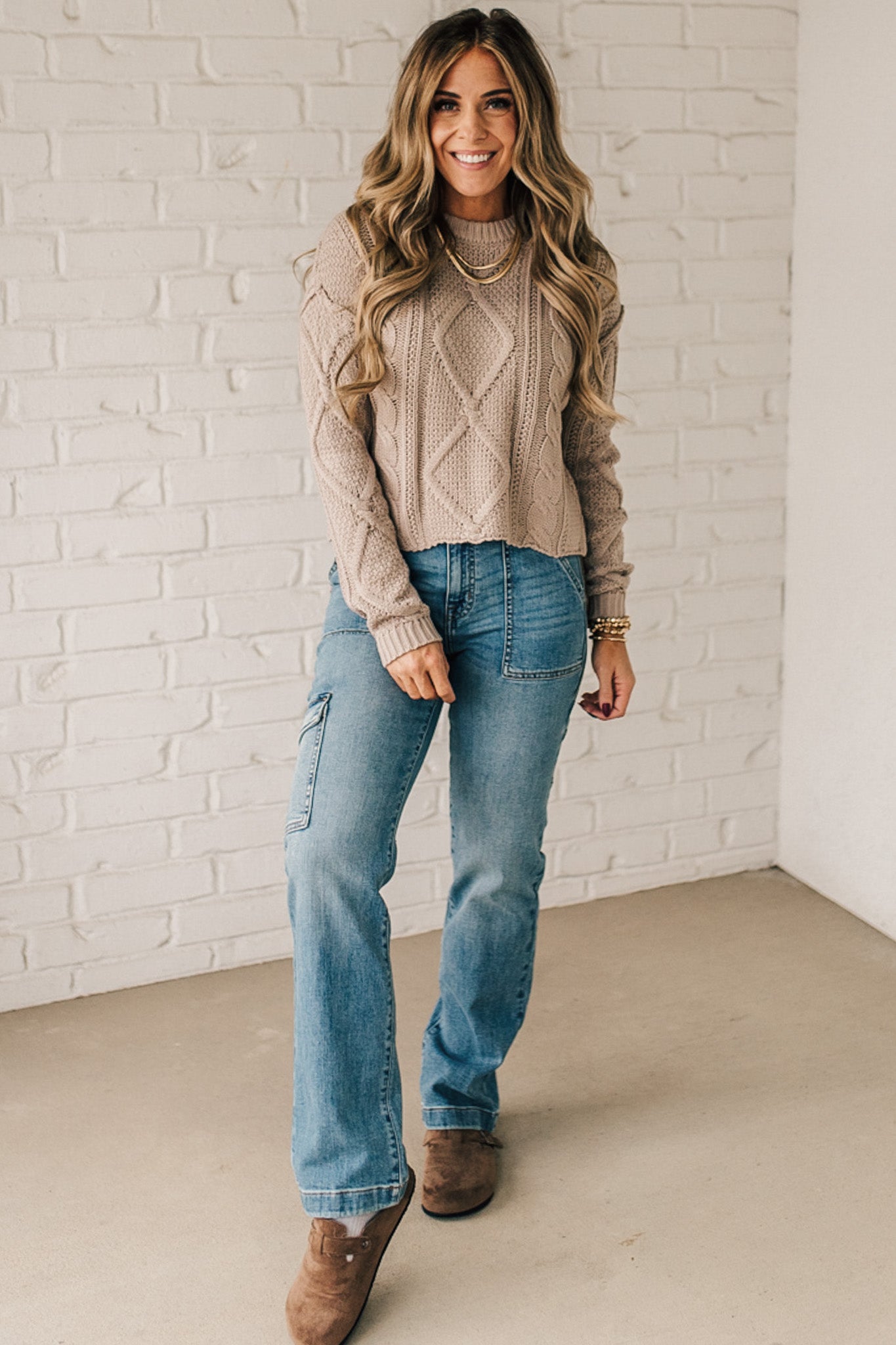 Blonde girl modeling a mocha long sleeve cable knit sweater
