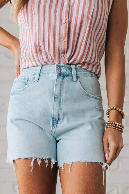 Woman Wearing Light Wash Comfort Stretch Distressed Hem Denim Shorts