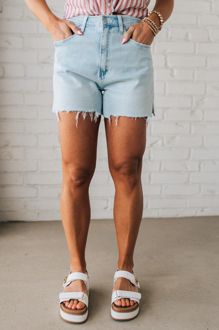 Woman Wearing Light Wash Comfort Stretch Distressed Hem Denim Shorts