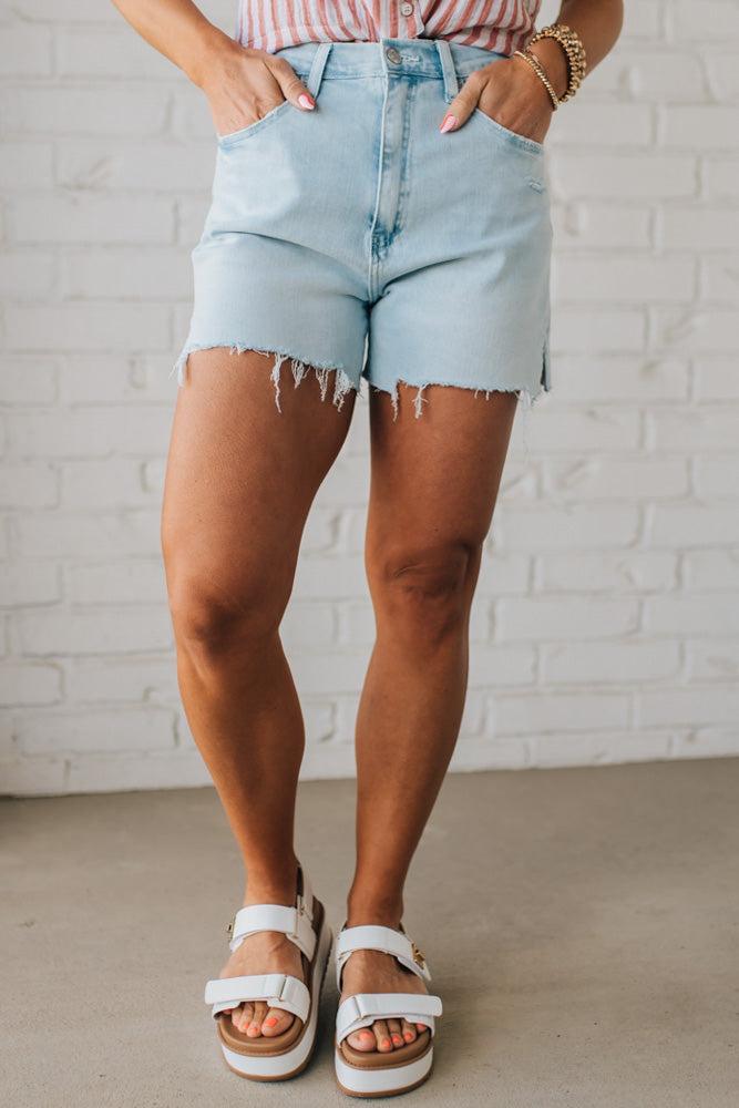 Woman Wearing Light Wash Comfort Stretch Distressed Hem Denim Shorts