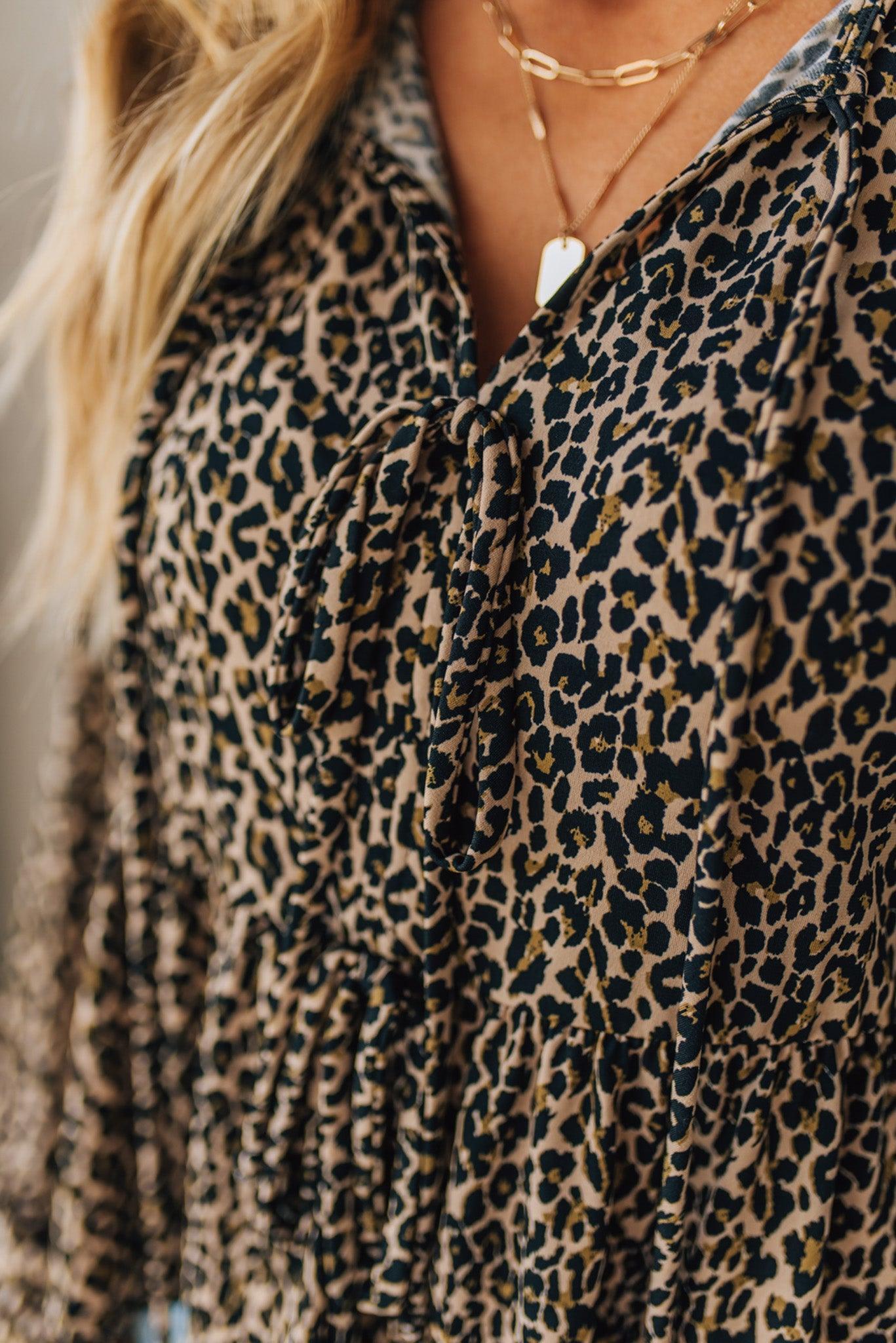 Leopard print garment with a necklace worn by a person
