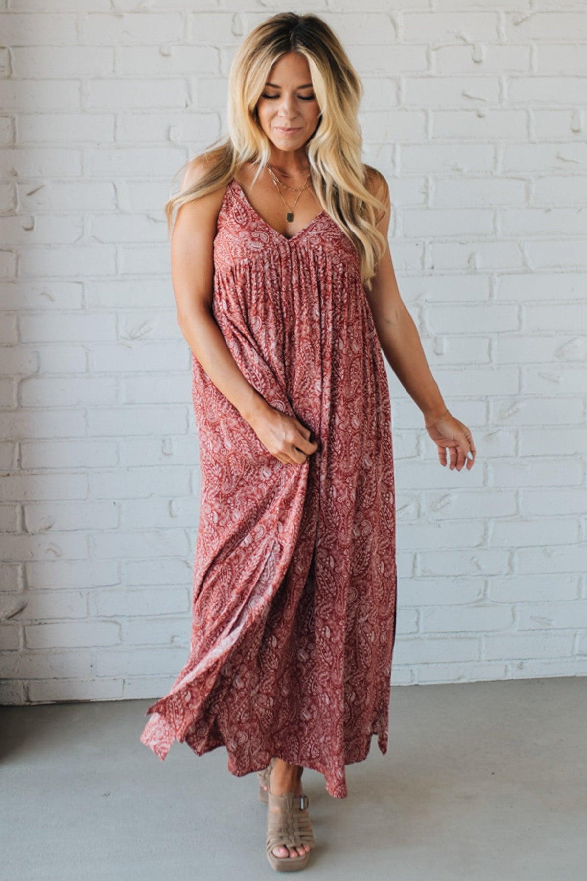 Blonde woman wearing a red Paisley Print Maxi Dress With Adjustable Straps.