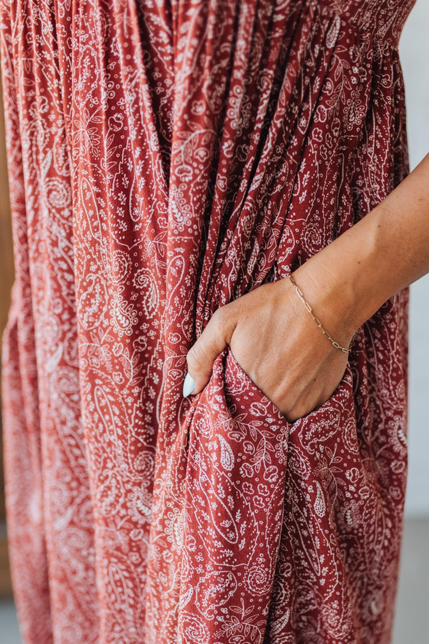 Blonde woman wearing a red Paisley Print Maxi Dress With Adjustable Straps.