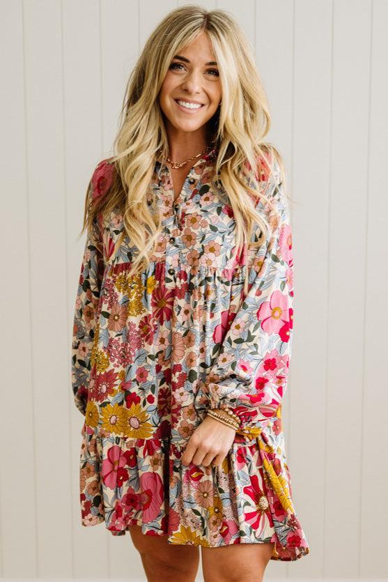 Woman wearing a floral dress against a wooden panel background