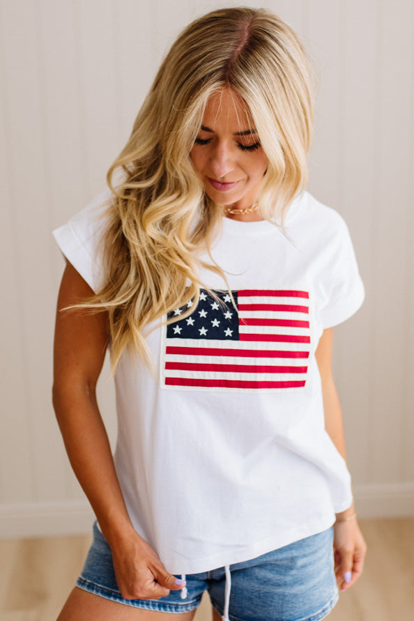 Woman wearing a white t-shirt with an American flag design.
