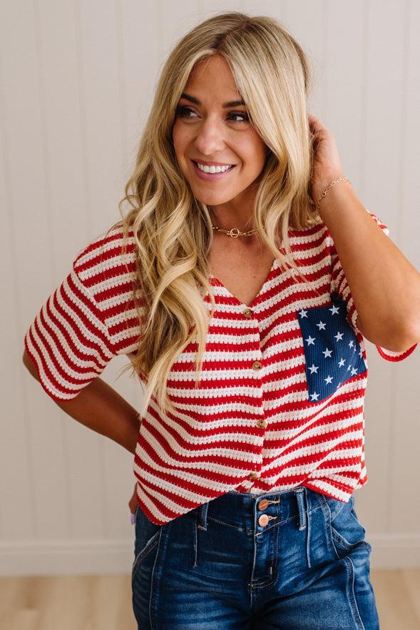 Woman wearing a red and white striped shirt with an American flag design.