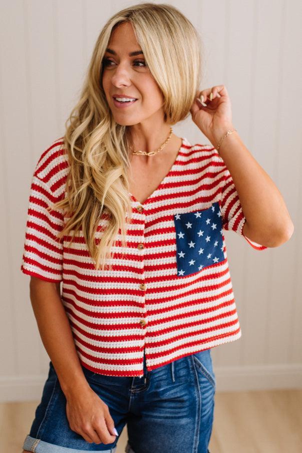 Woman wearing a red, white, and blue striped shirt with an American flag design.