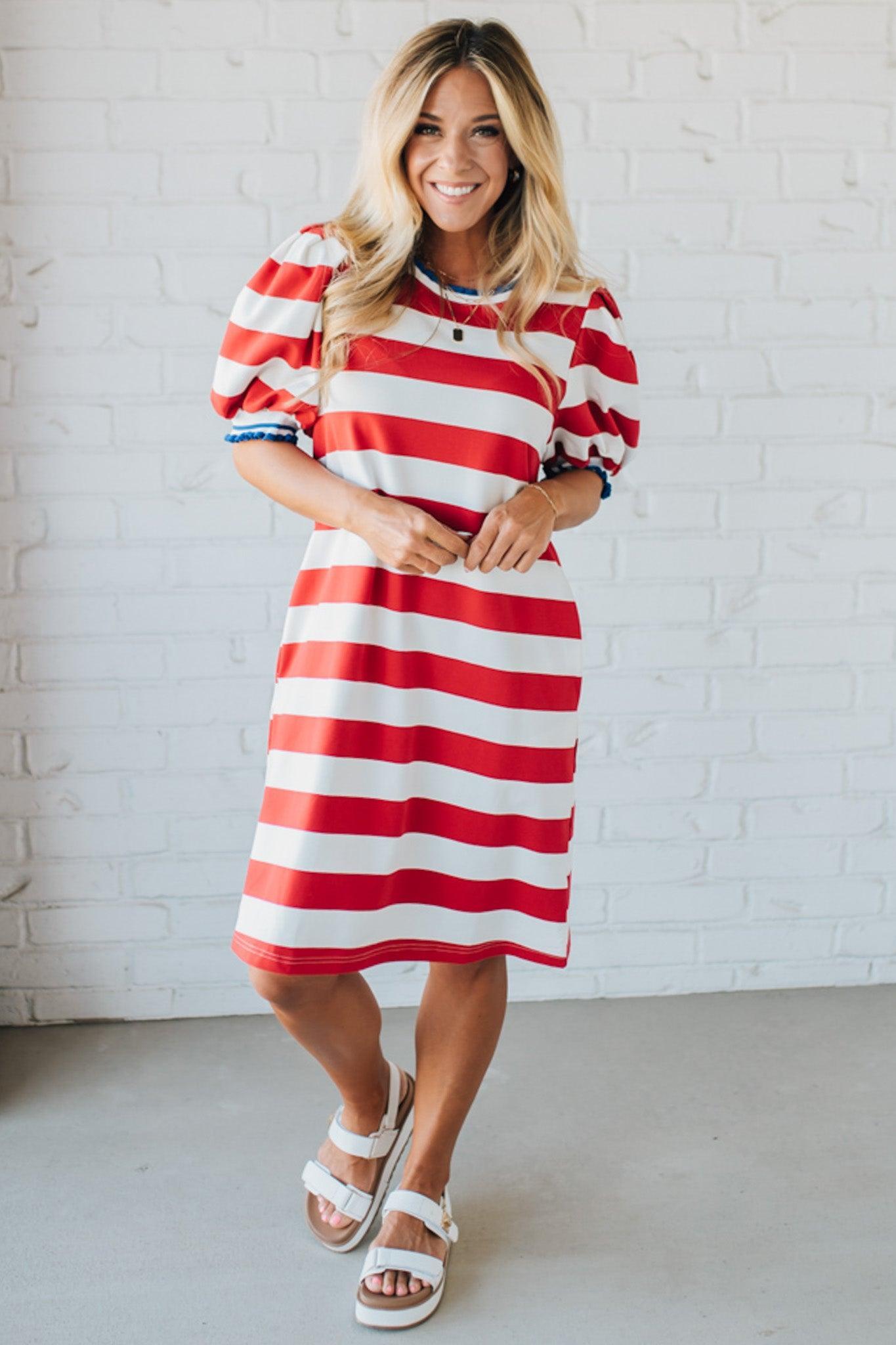 Blonde Woman Wearing a Ruffle Ribbed Detail Stripe French Terry Mini Dress with bright red thick stripes.