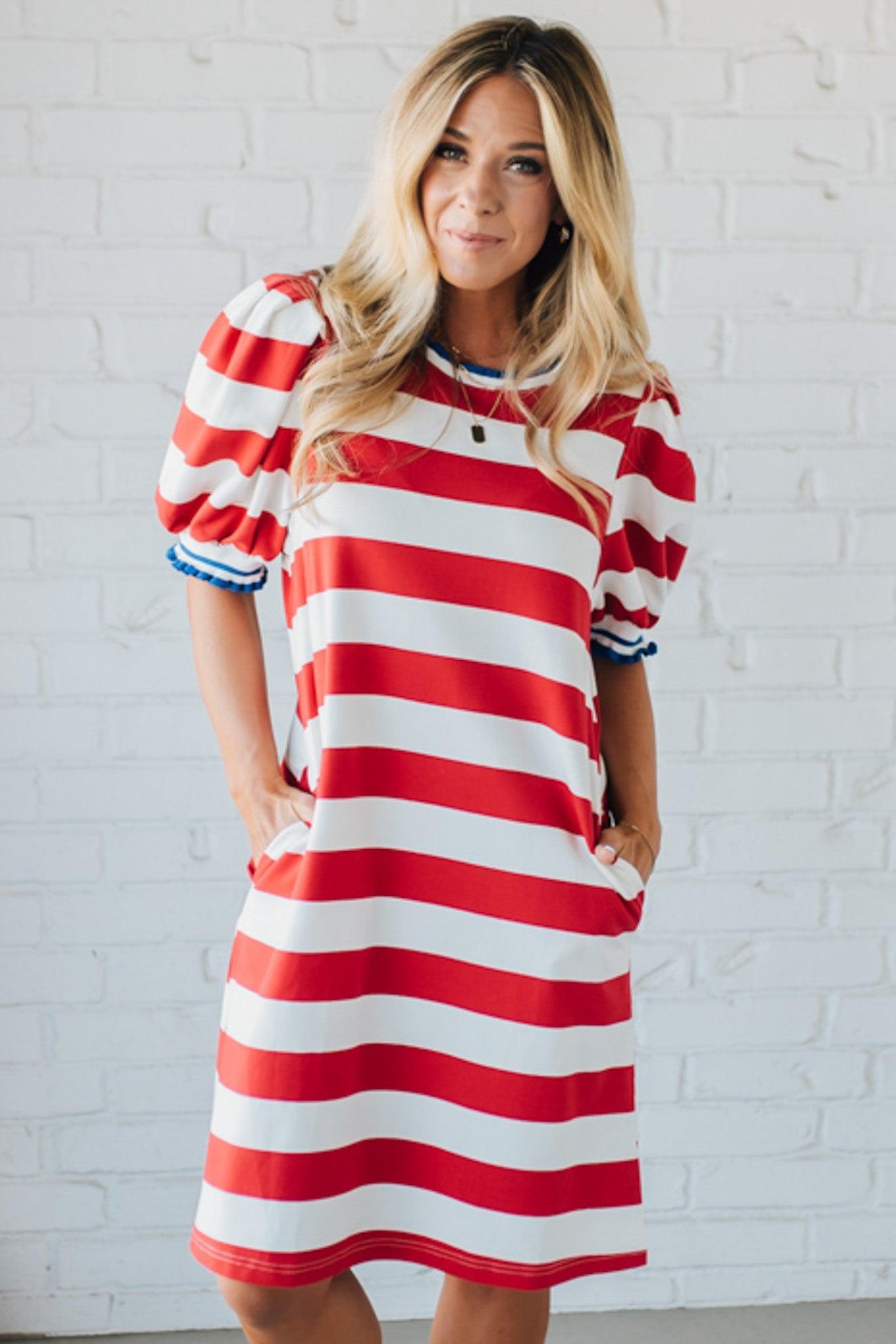 Blonde Woman Wearing a Ruffle Ribbed Detail Stripe French Terry Mini Dress with bright red thick stripes.