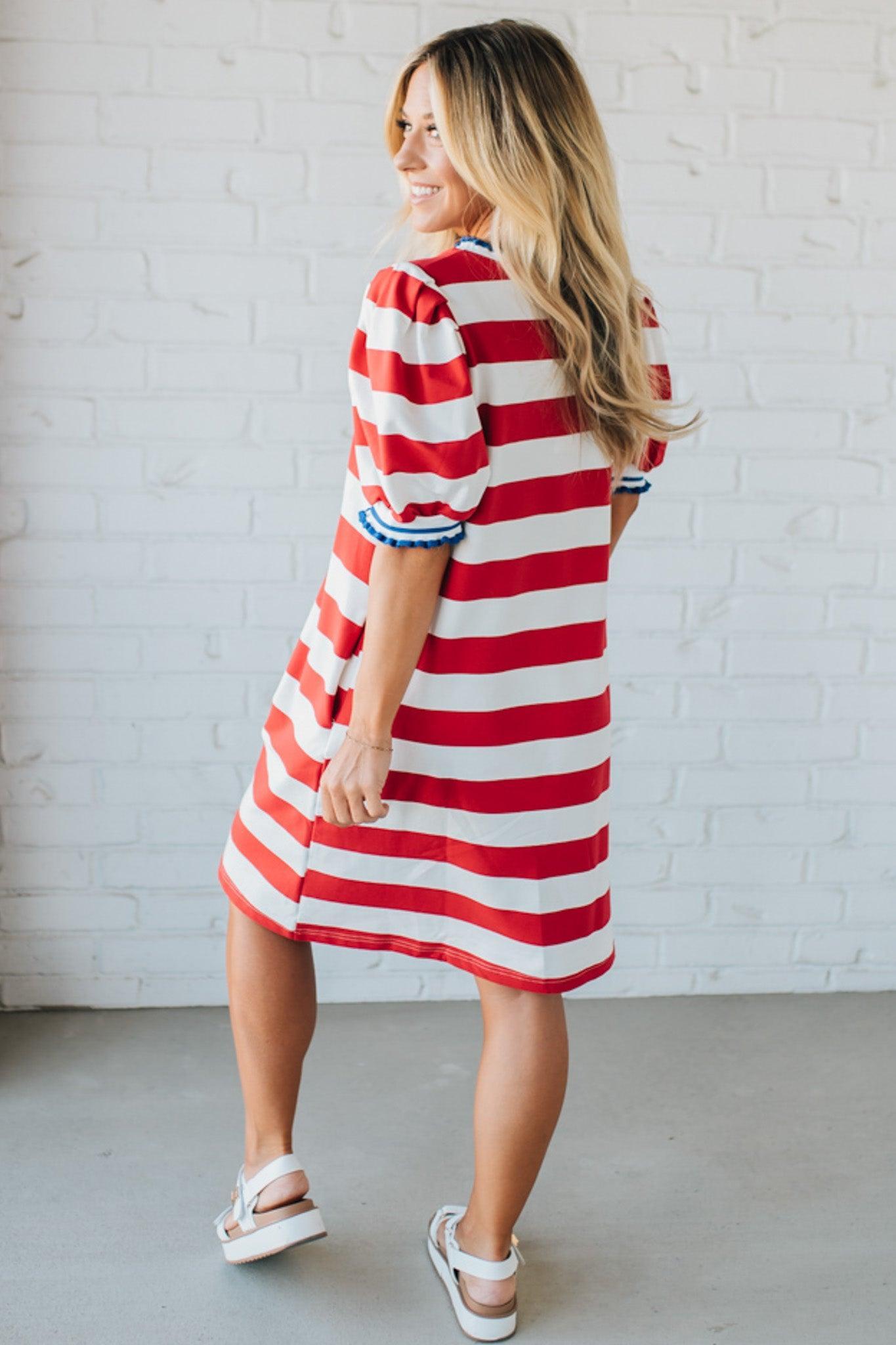 Blonde Woman Wearing a Ruffle Ribbed Detail Stripe French Terry Mini Dress with bright red thick stripes.