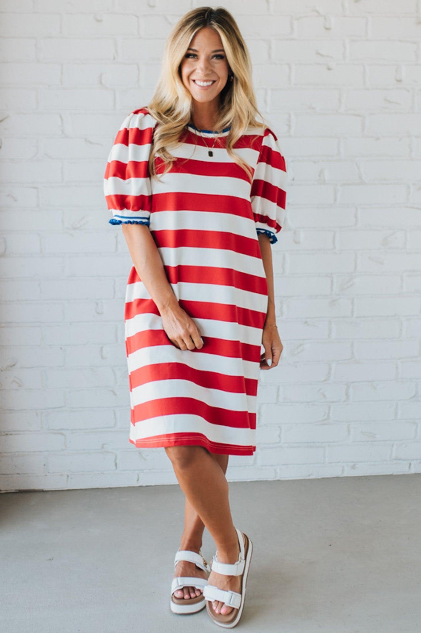Blonde Woman Wearing a Ruffle Ribbed Detail Stripe French Terry Mini Dress with bright red thick stripes.