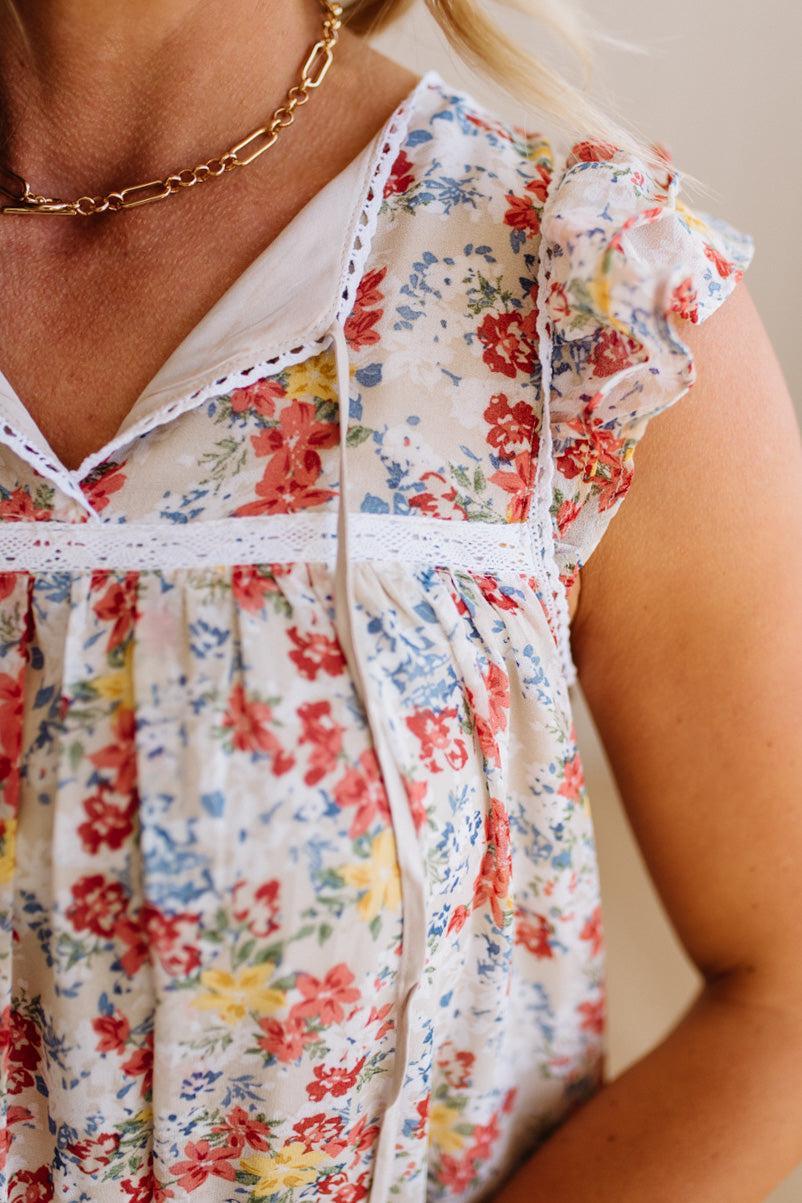 Woman wearing a floral dress with a neutral background
