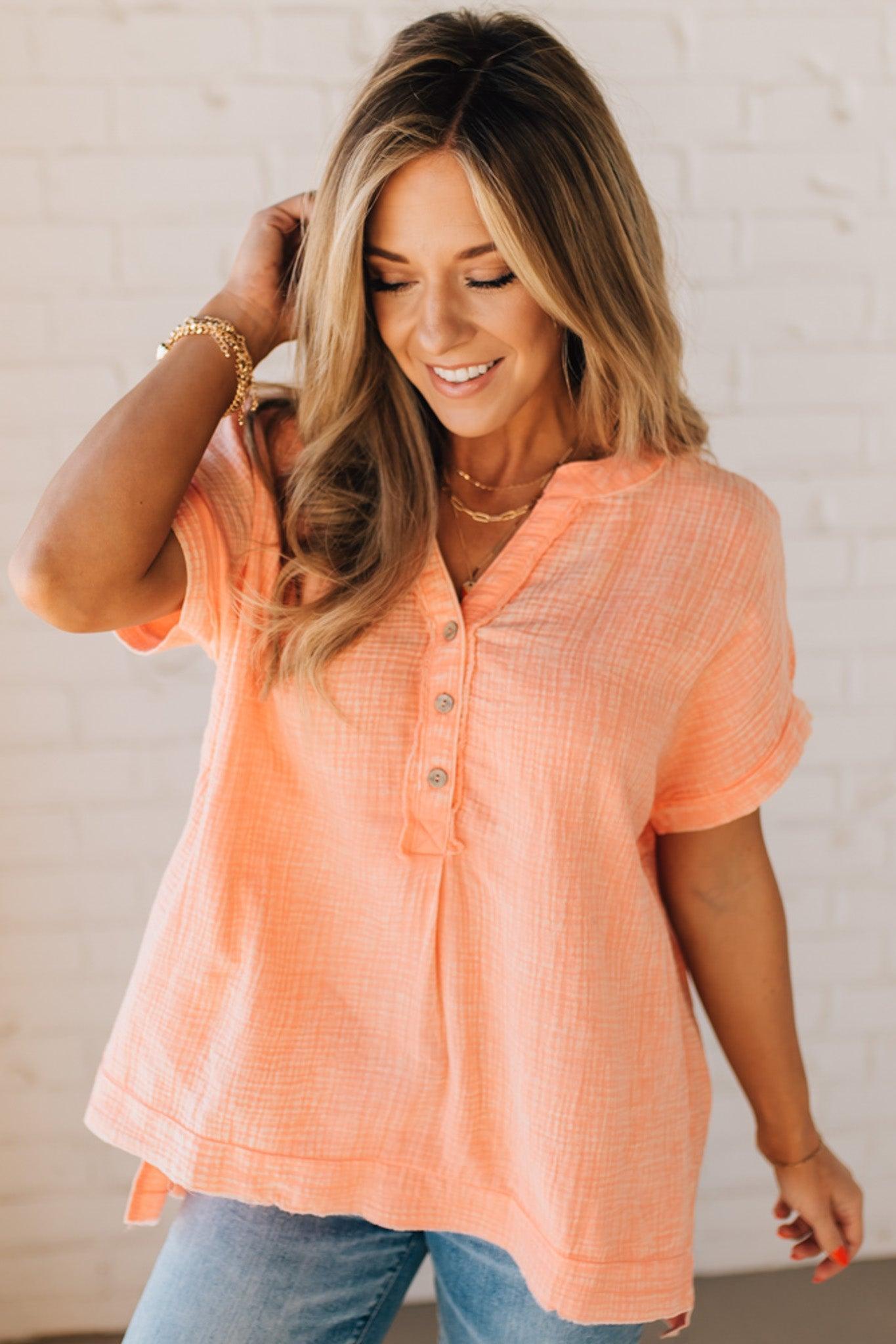 BLONDE WOMAN WEARING A WASHED DOUBLE GAUZE 3/4 BUTTON HENLEY NECK SHIRT.