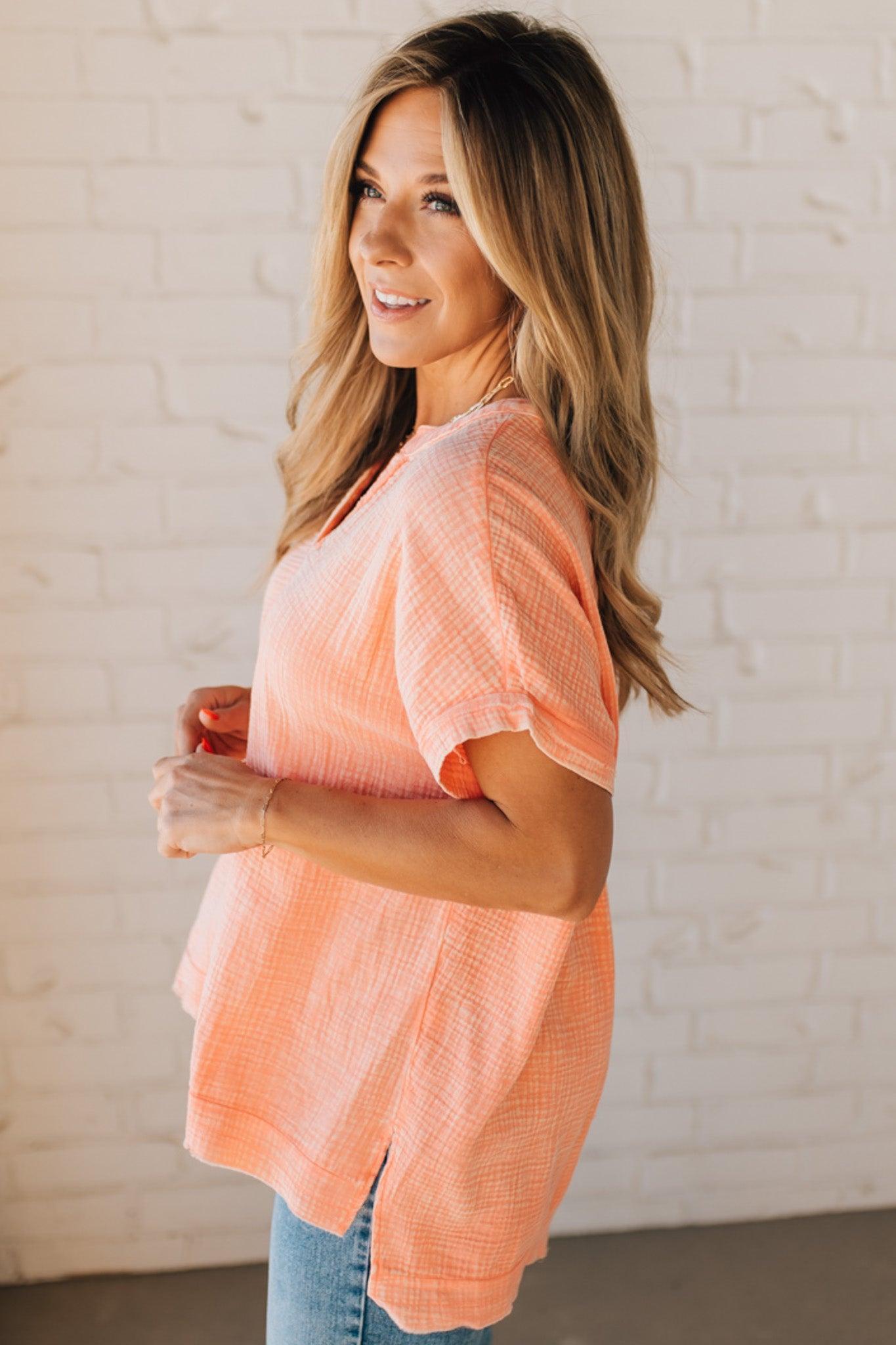BLONDE WOMAN WEARING A WASHED DOUBLE GAUZE 3/4 BUTTON HENLEY NECK SHIRT.
