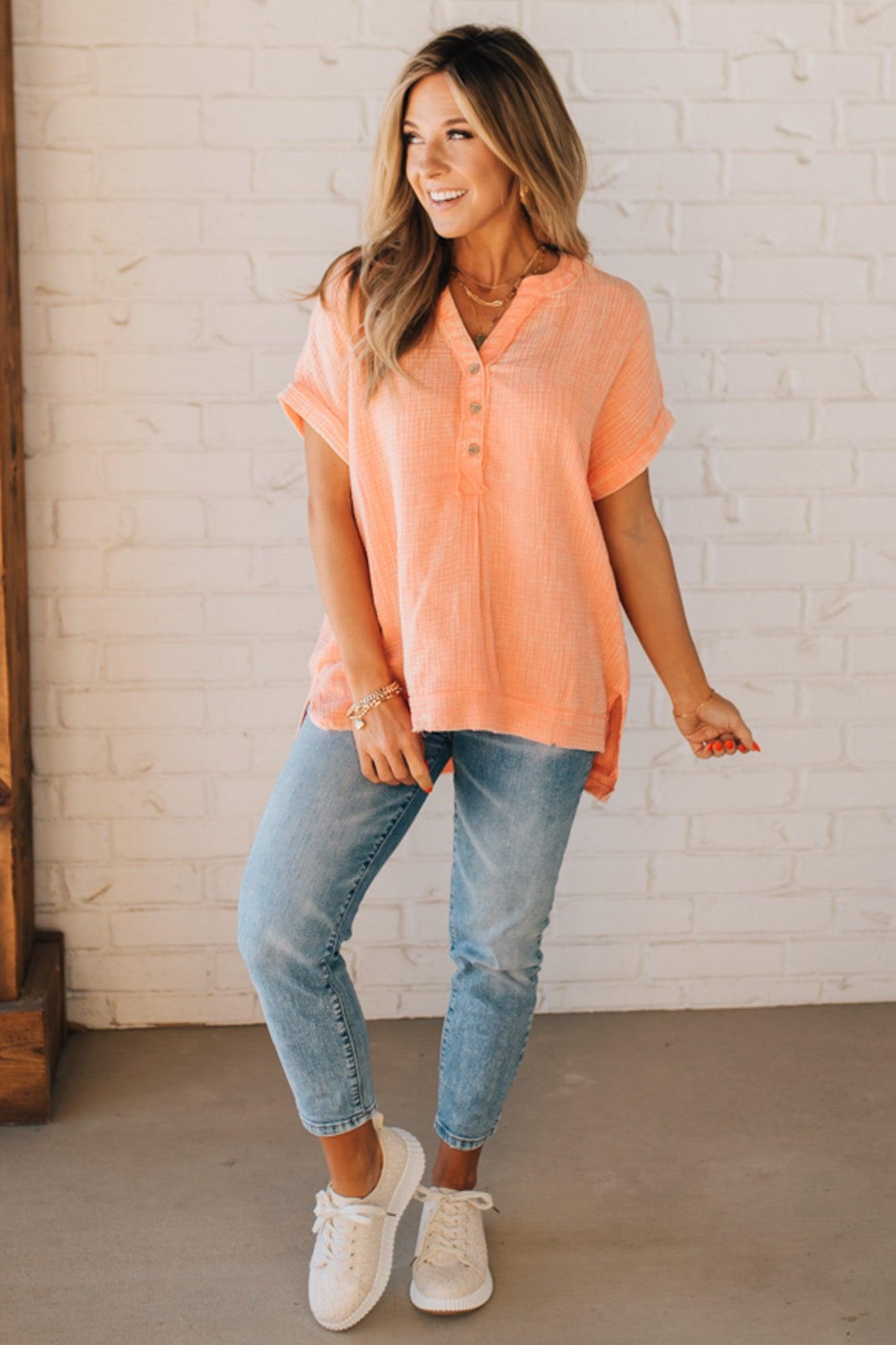 BLONDE WOMAN WEARING A WASHED DOUBLE GAUZE 3/4 BUTTON HENLEY NECK SHIRT.