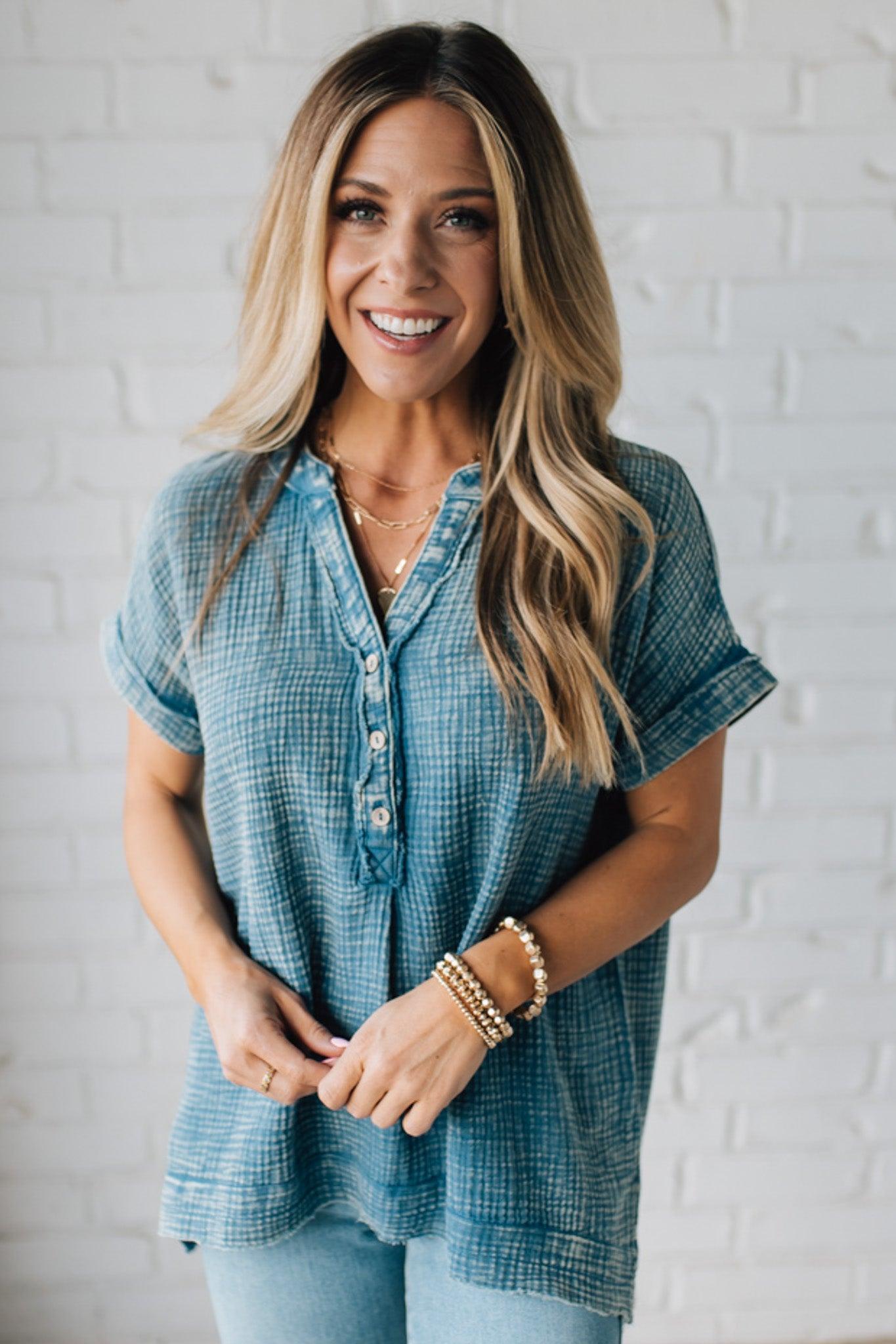 BLONDE WOMAN WEARING A WASHED DOUBLE GAUZE 3/4 BUTTON HENLEY NECK SHIRT.