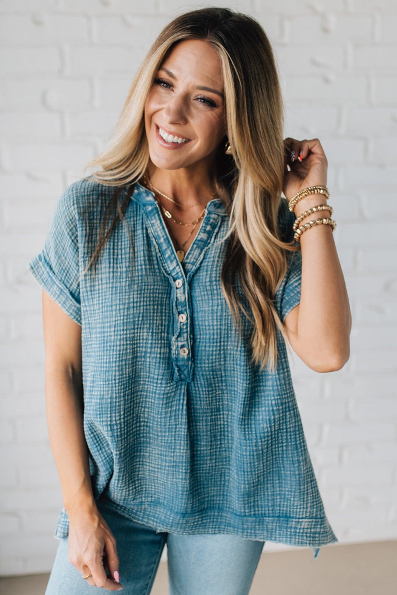 BLONDE WOMAN WEARING A WASHED DOUBLE GAUZE 3/4 BUTTON HENLEY NECK SHIRT.