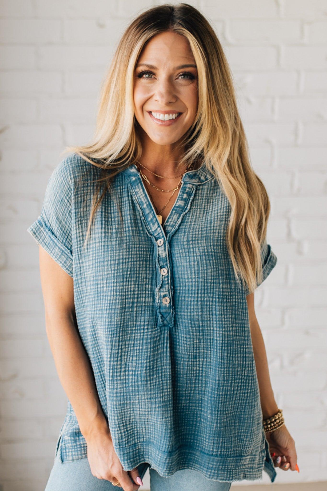 BLONDE WOMAN WEARING A WASHED DOUBLE GAUZE 3/4 BUTTON HENLEY NECK SHIRT.