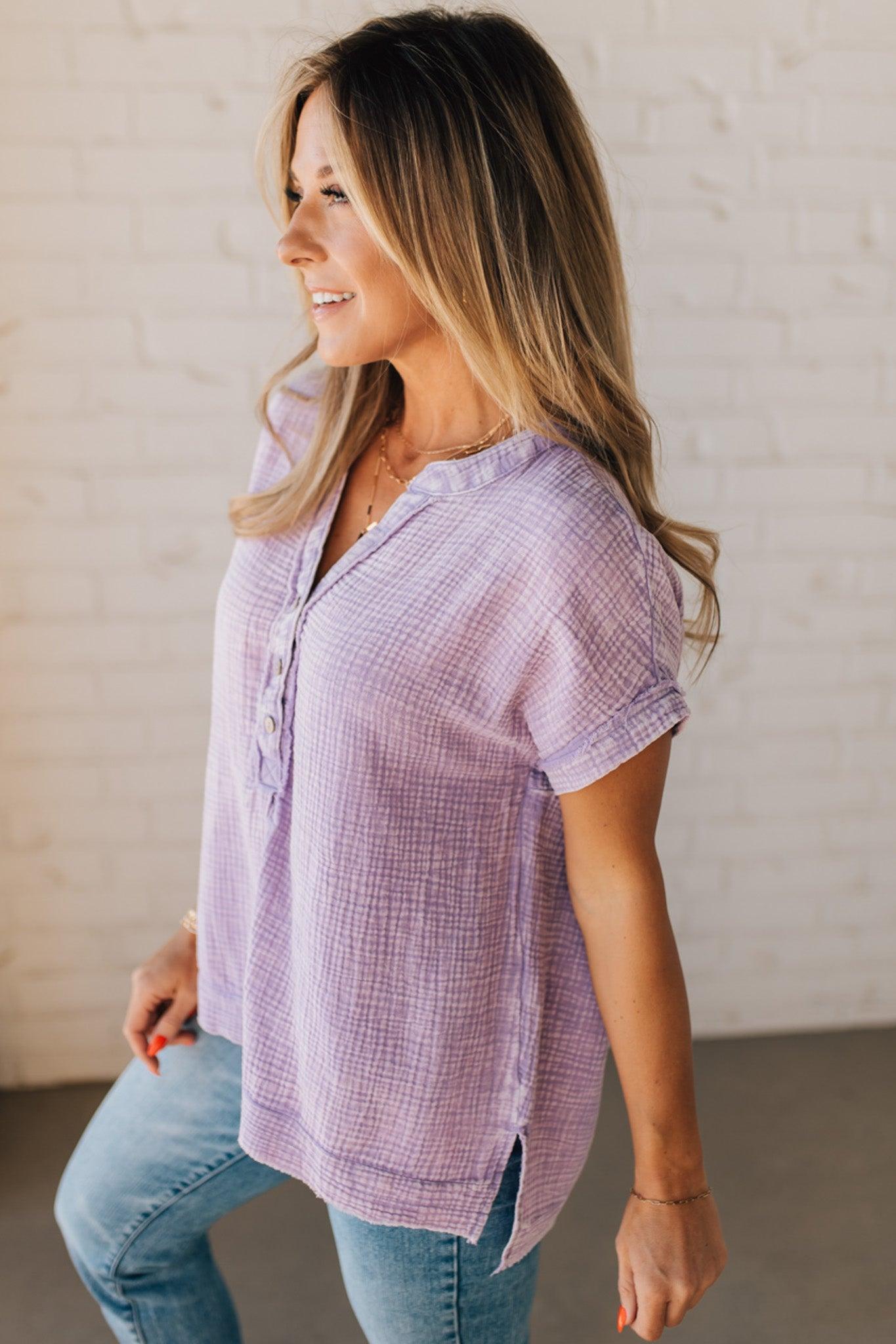 BLONDE WOMAN WEARING A WASHED DOUBLE GAUZE 3/4 BUTTON HENLEY NECK SHIRT.