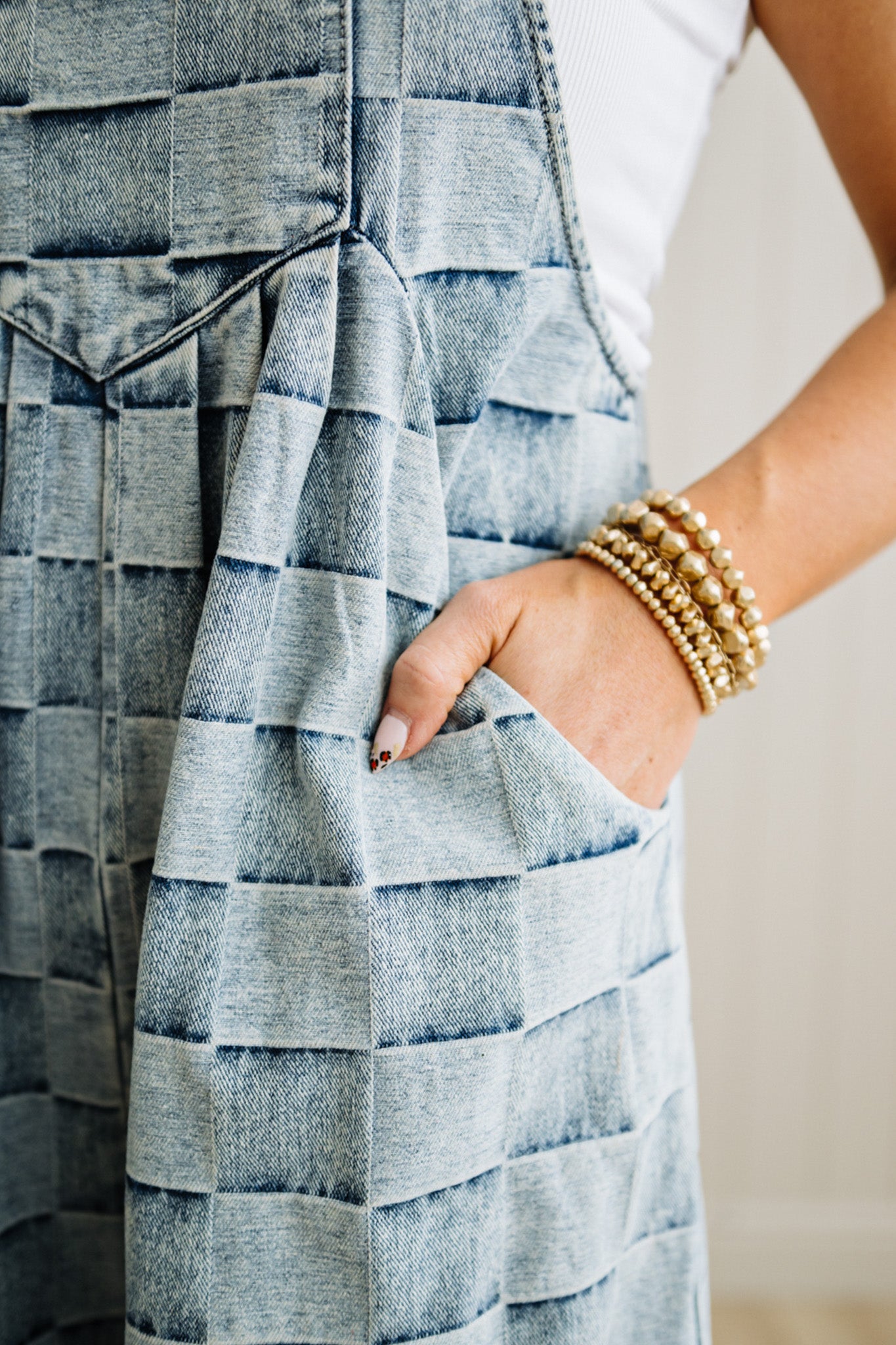 Close-up of a person wearing a textured dress with a neutral background