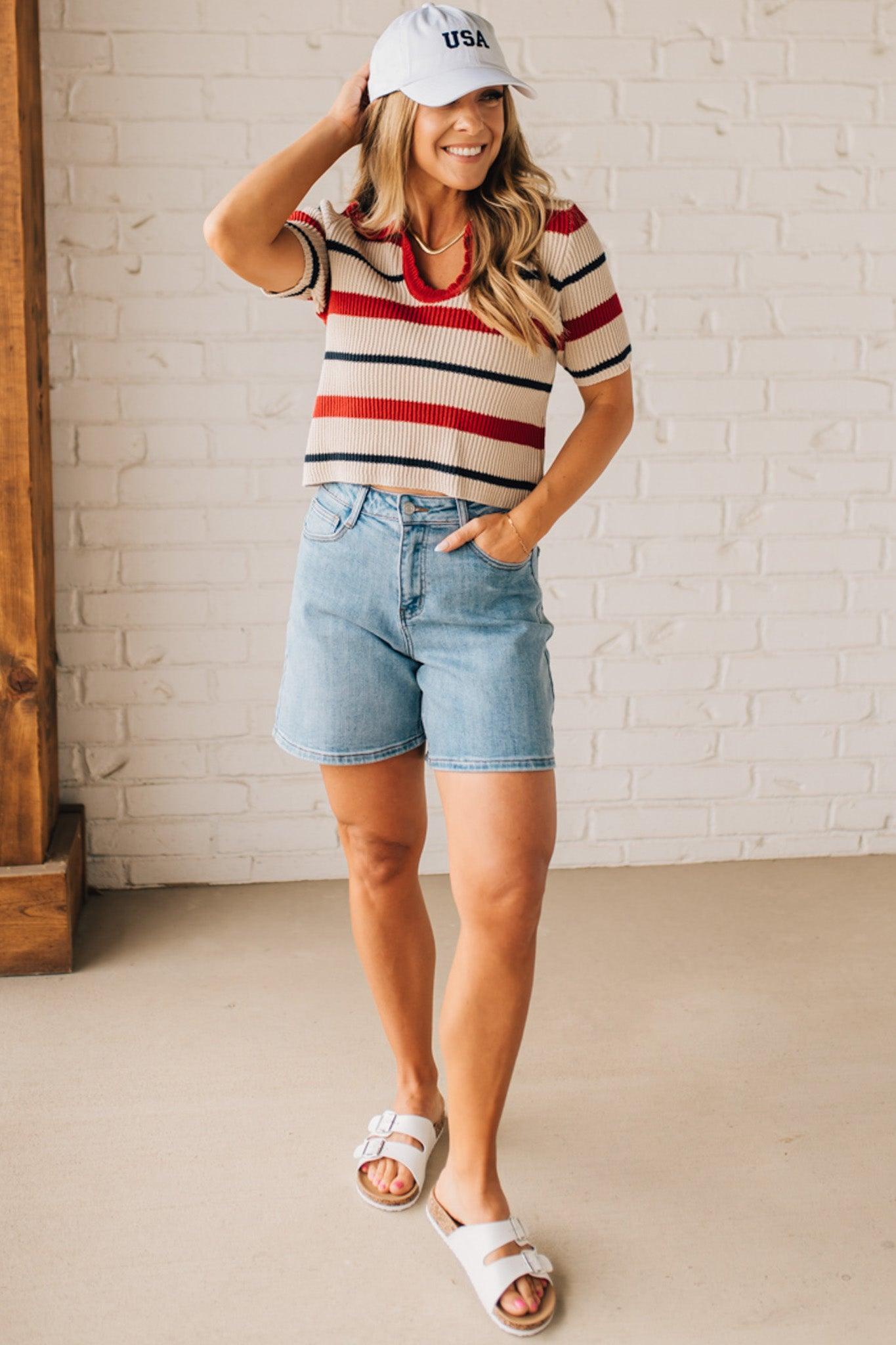 Blonde Woman in a White Hat Wearing a Striped Collared Short Sleeve Cropped Sweater