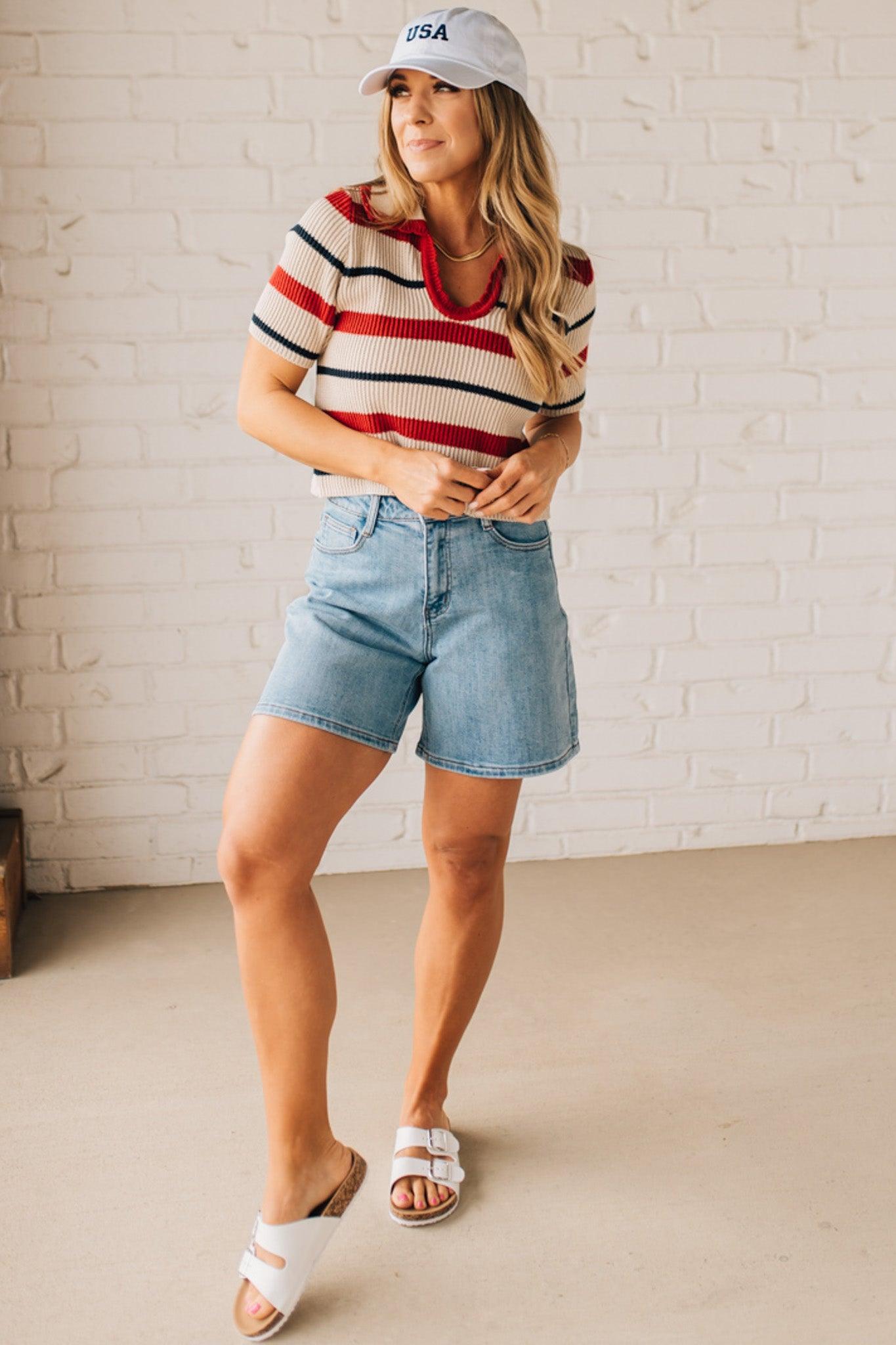 Blonde Woman in a White Hat Wearing a Striped Collared Short Sleeve Cropped Sweater