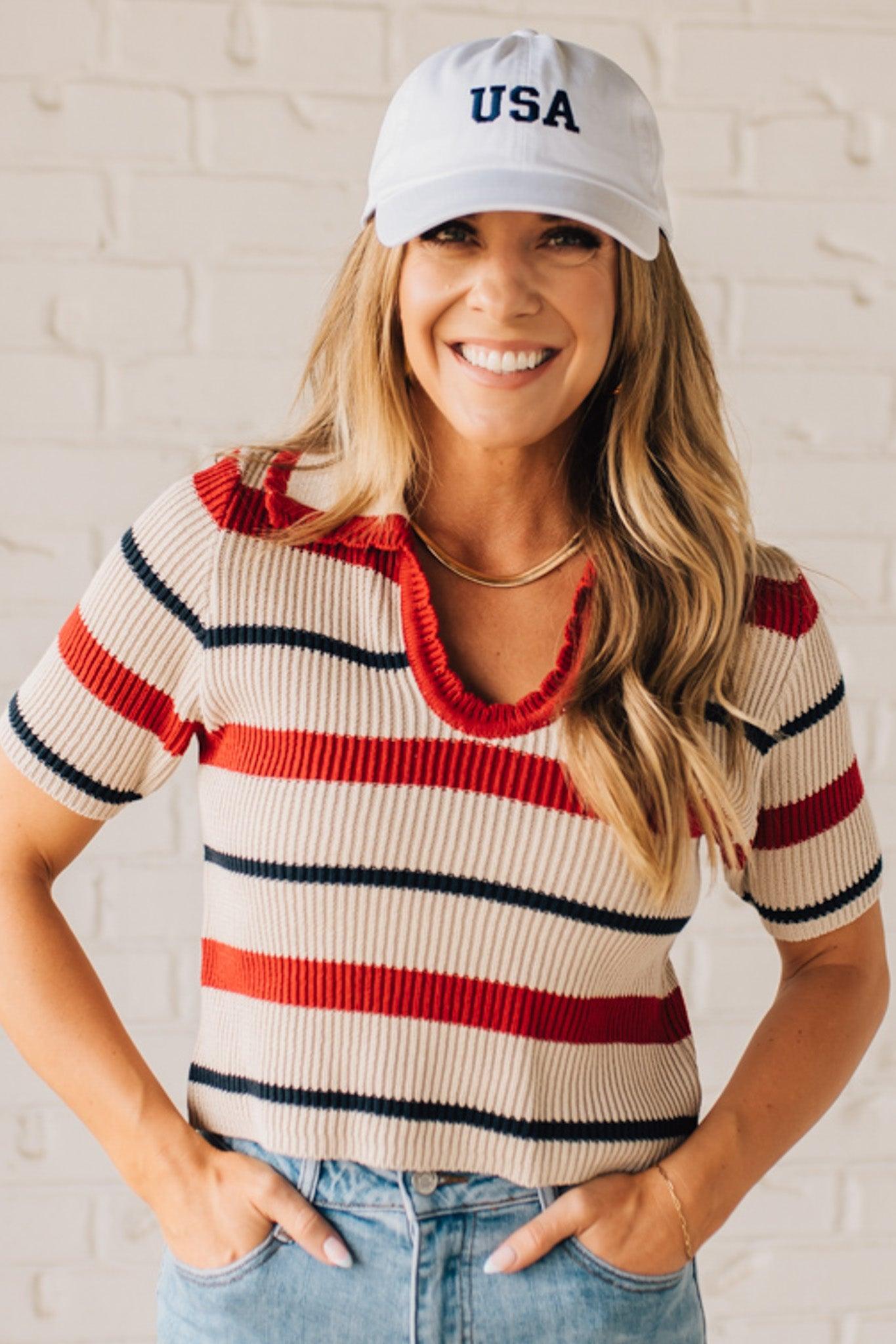 Blonde Woman in a White Hat Wearing a Striped Collared Short Sleeve Cropped Sweater