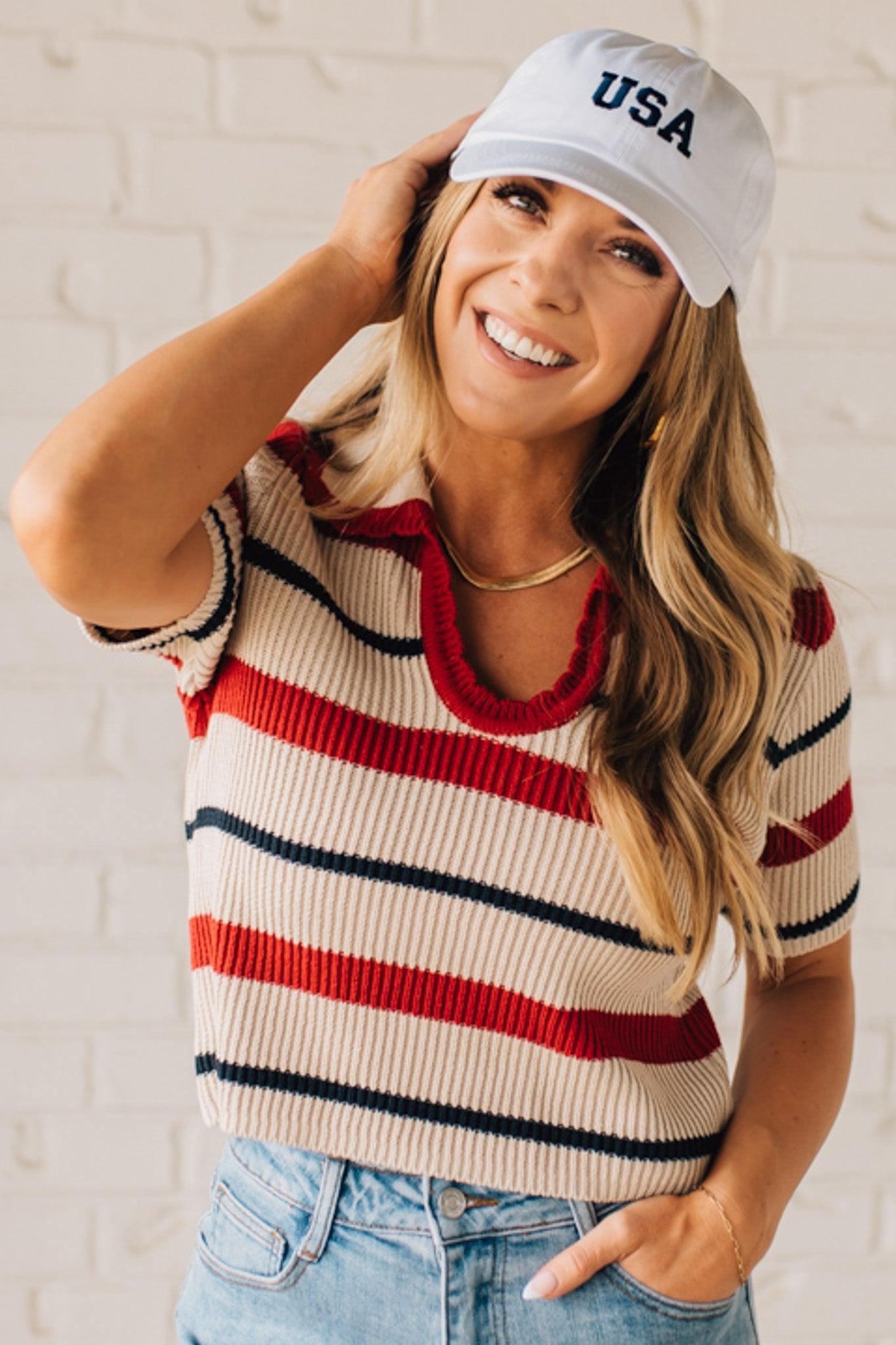 Blonde Woman in a White Hat Wearing a Striped Collared Short Sleeve Cropped Sweater